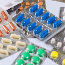 Various pills are on table in medical office doctor